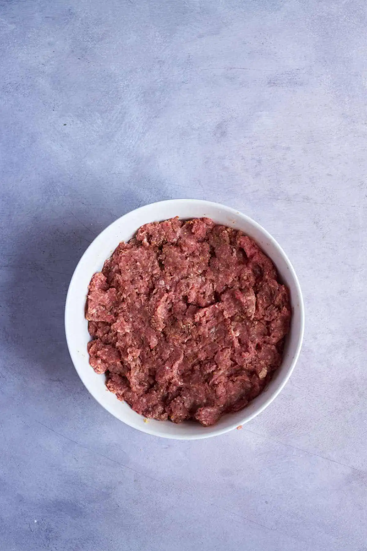 The ground meat mixed with the ingredients.