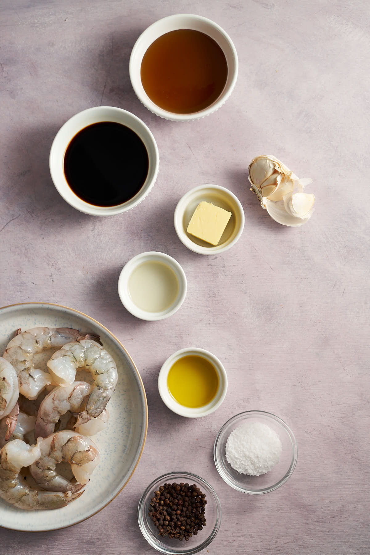 Ingredients for air fryer honey garlic shrimp including shrimp, honey, garlic, soy sauce, butter, and olive oil