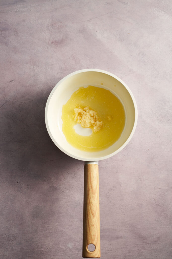 Butter and garlic melting in a saucepan for honey garlic sauce