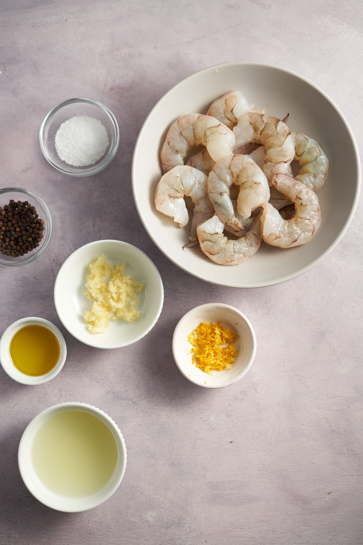 Ingredients for air fryer lemon garlic shrimp including shrimp, garlic, lemon, olive oil, and seasonings