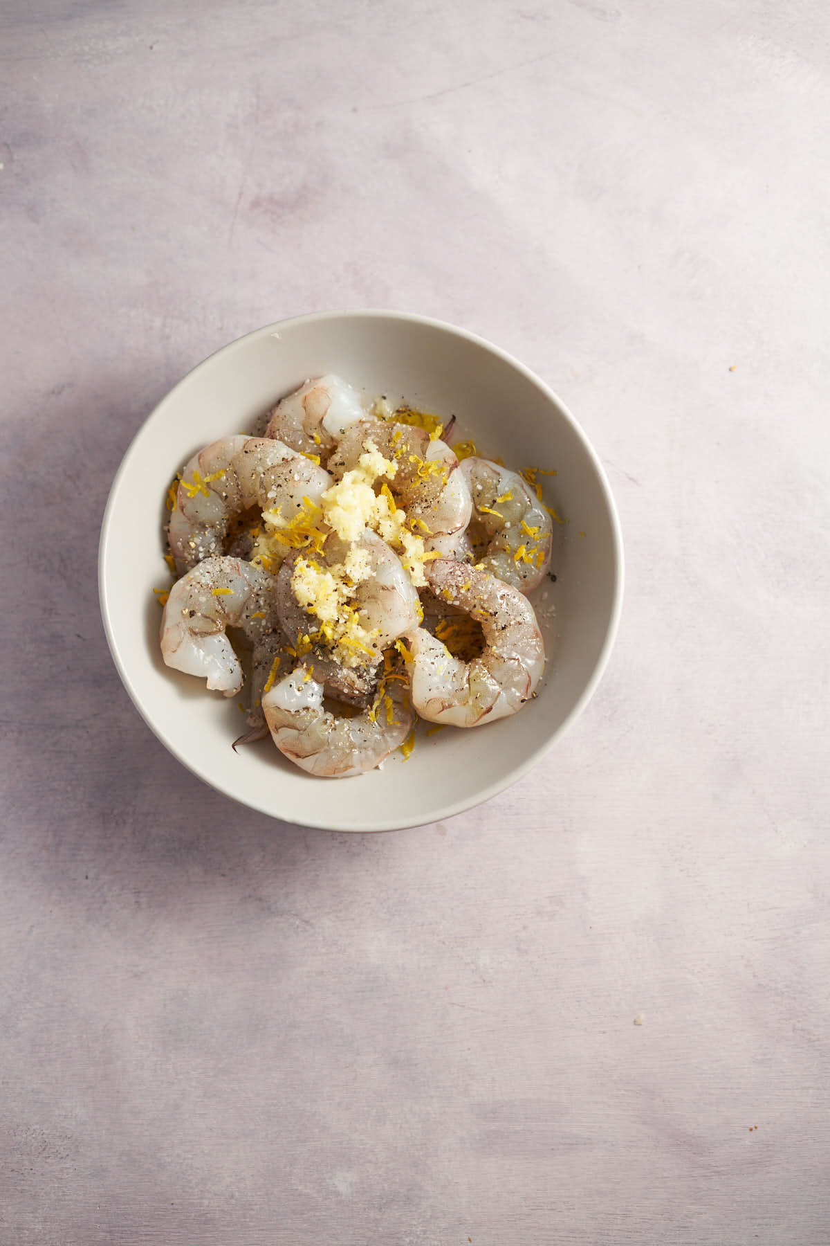 Raw shrimp coated with garlic, lemon, olive oil, and seasonings before air frying