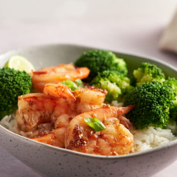 Honey Garlic Shrimp serve over rice with broccoli in a bowl.