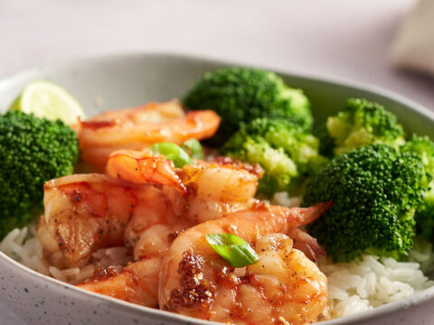 Honey Garlic Shrimp serve over rice with broccoli in a bowl.