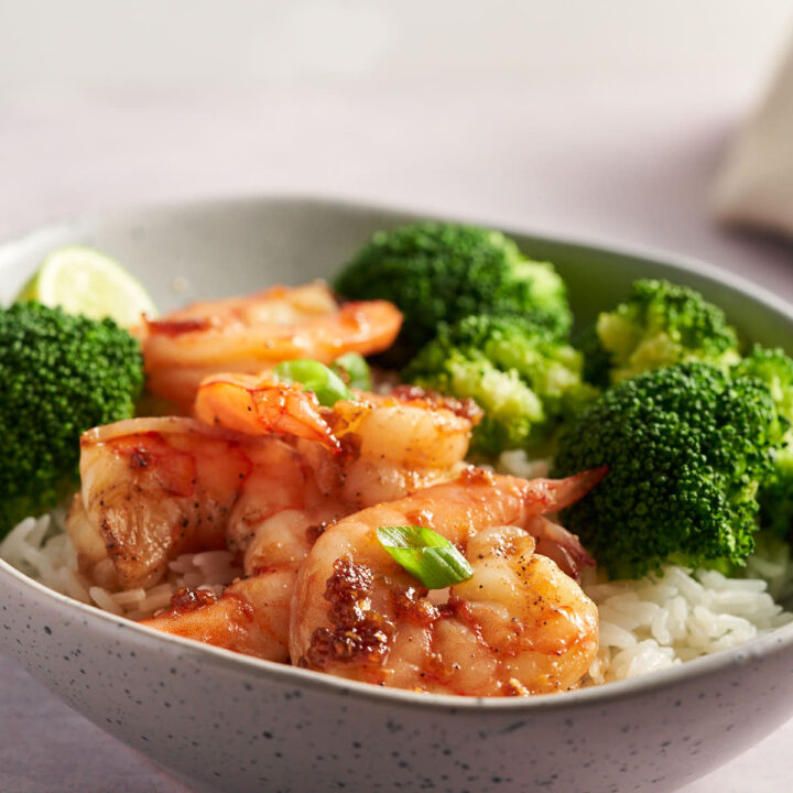 Honey Garlic Shrimp serve over rice with broccoli in a bowl.