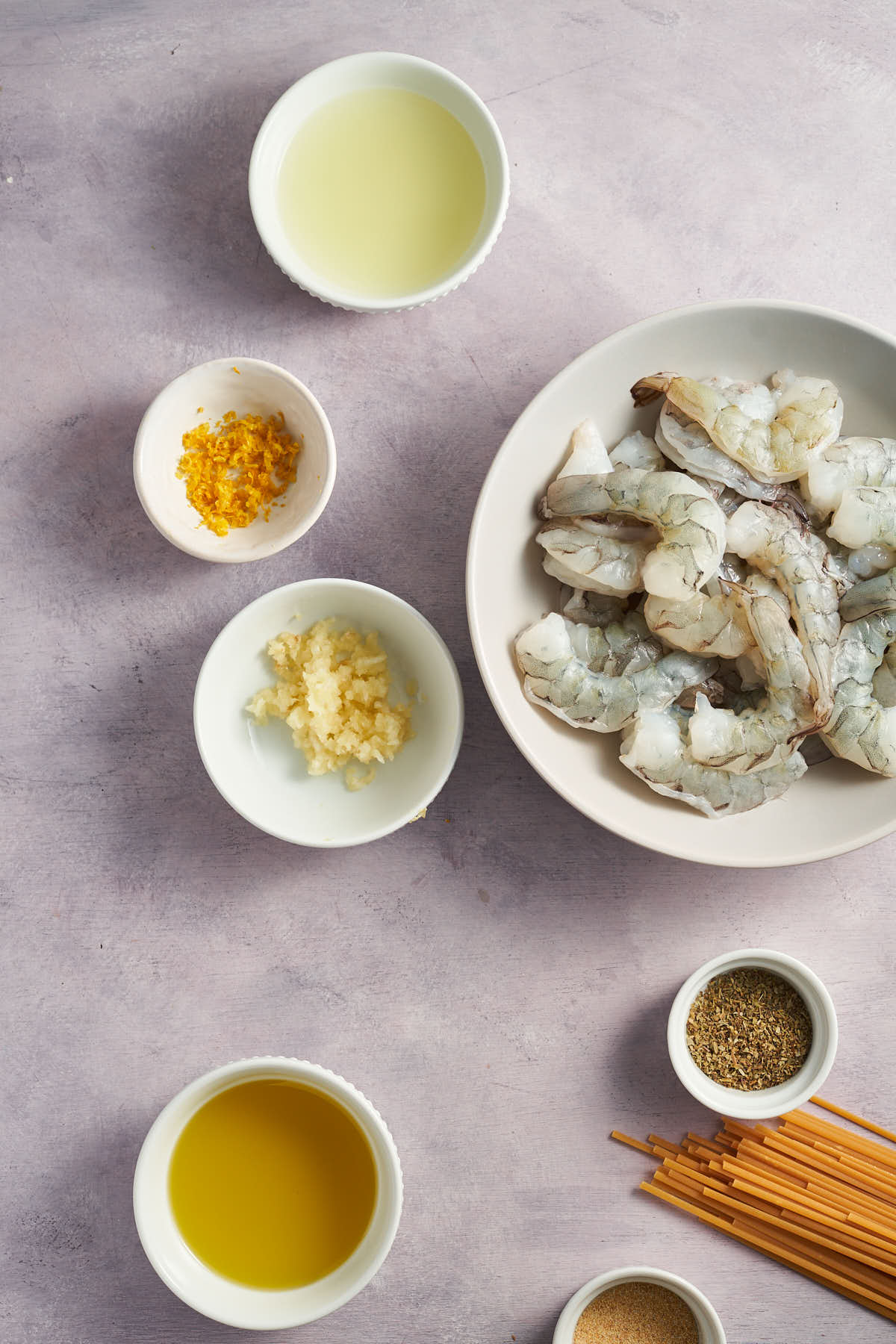 Ingredients for lemon garlic shrimp pasta arranged on a tabletop.