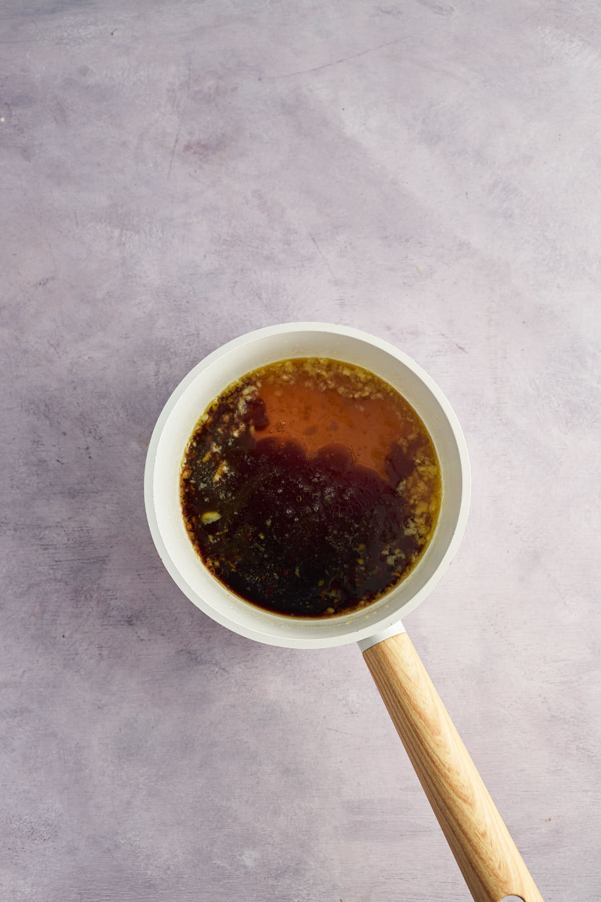 Honey garlic sauce ingredients in a small saucepan before mixing.
